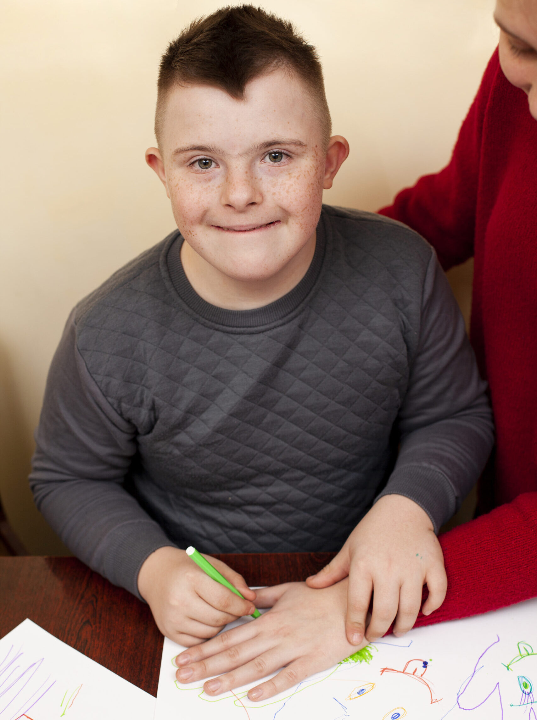 happy-boy-with-down-syndrome-drawing-scaled-e1761917359415